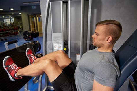 Man Flexing Leg Muscles On Gym Machine Stock Image Colourbox
