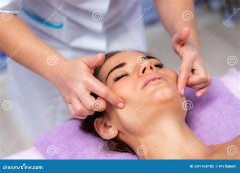 Relaxing Massage European Woman Getting Facial Massage In Spa Salon Side View Stock Image
