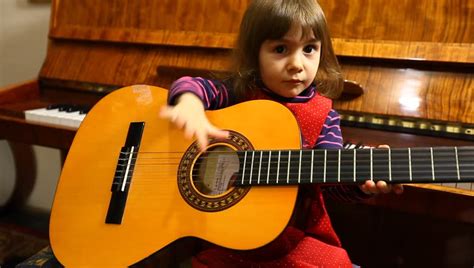Little Baby Girl Plays Guitar Stock Footage Video 100 Royalty Free