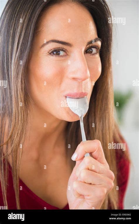 Smiling Caucasian Woman Licking Spoon Stock Photo Alamy