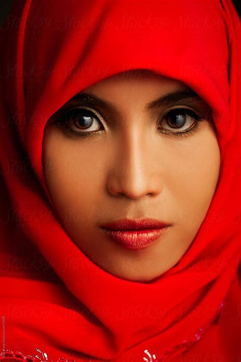 portrait of a beautiful muslim woman in traditional red hijab by nabi tang stocksy united