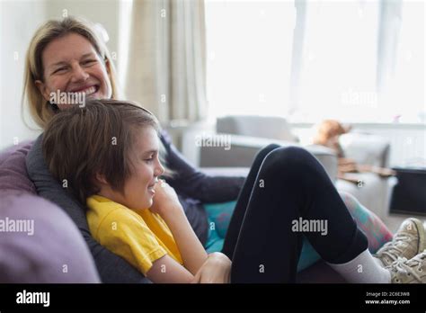 Portrait Happy Mother And Son On Living Room Sofa Stock Photo Alamy