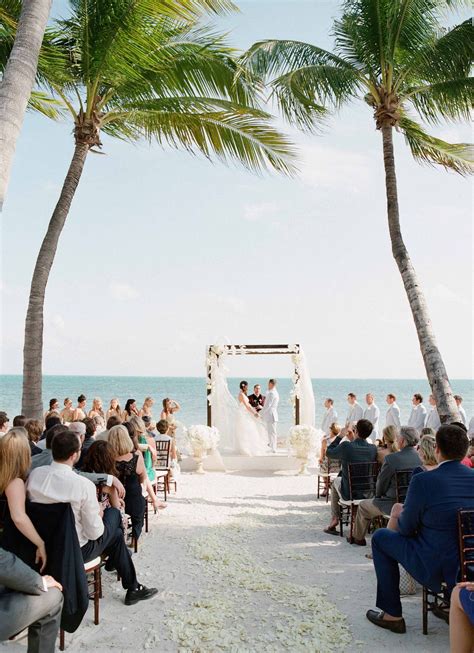 beach wedding between palm trees