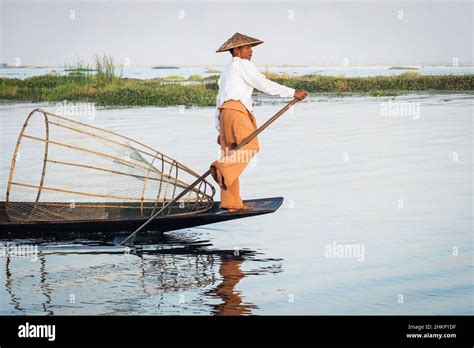 Intha Fisherman Leg Rowing In Traditional Style On Inle Lake Shan