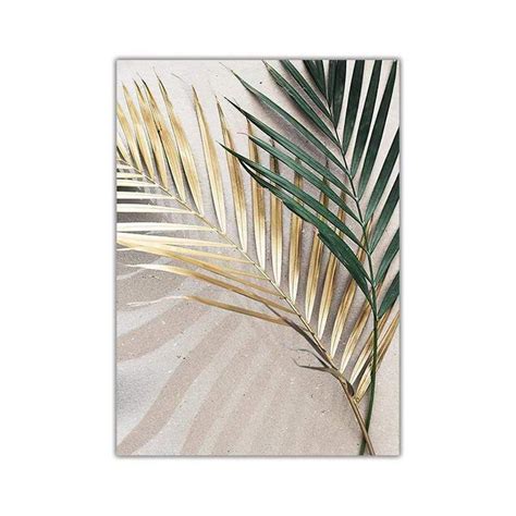 A Palm Leaf On A White Background With Gold Foil Leaves In The
