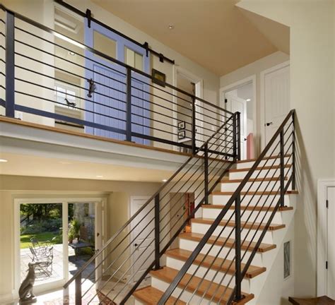 This one has a black curvy design that matches the curves of the stairs and surrounding furniture. Choosing the Perfect Stair Railing Design Style
