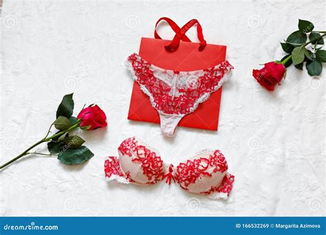 Women`s Erotic Underwear And Red Roses On White Surface Red Lacy Lingerie On White Background