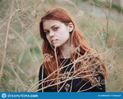 woman with red hair in a field in nature black dress close up stock image image of nature
