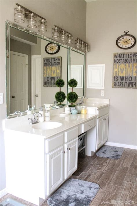 This bathroom went from a warm farmhouse style to a cool, elegant gray look after its makeover was completed. Master Bathroom Makeover