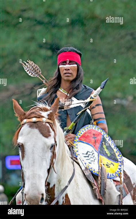 A Native American Indian Decorated And Dressed In Traditional Warrior