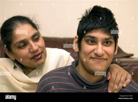 mother with her 24 year old daughter at home who suffers with cerebral palsy london uk model