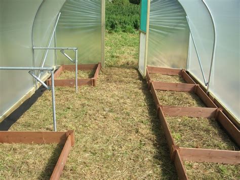A Newly Built Polytunnel Layout With Raised Beds And Staging Supports