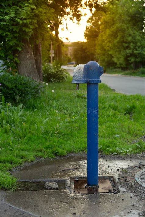 A Blue Street Water Pump In The Old Part Of The City Stock Photo