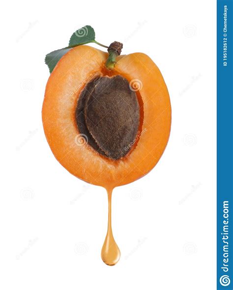 Apricot Kernel Oil Dripping From Fresh Fruit Half On Background Stock
