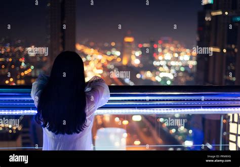 Woman Enjoying With Night City View From The Balcony Stock Photo Alamy