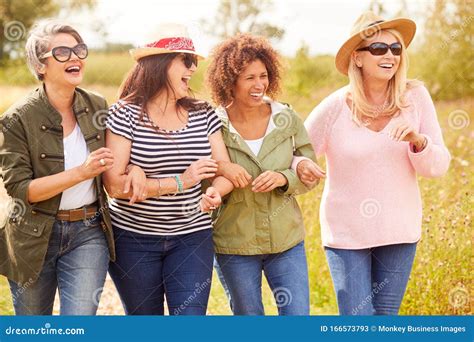 Group Of Mature Female Friends Walking Along Path Through Yurt Campsite Stock Image Image Of