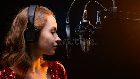 Lesson And Training In Vocal And Singing A Girl Sings Into A Microphone Bright Background