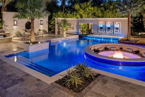 Tropical Pool With Sunken Fire Pit Seating Area Backyard Pool Swimming Pool Designs Backyard