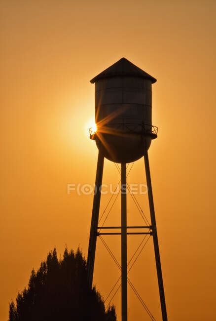 Sun Setting Behind Agricultural Water Tower — North America Rural