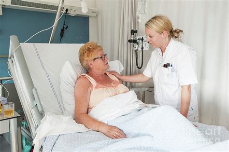 nurse talking to an elderly patient photograph by arno massee science photo library fine art