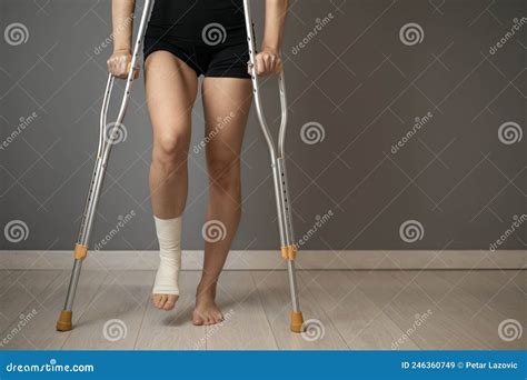 Disabled Woman Walking With Crutches And Sprained Ankle Stock Image