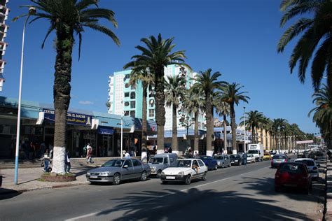To the southwest by mali, mauritania, and western sahara; Downtown Skikda with road and traffic in Algeria image ...