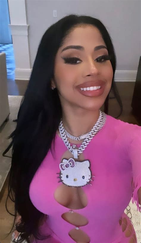 a woman in a pink dress with a hello kitty necklace