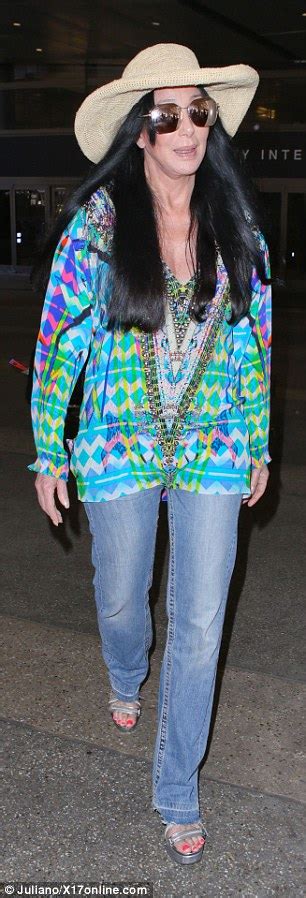 Cher In Bell Bottoms And Multi Coloured Shirt As She Jets Into Los