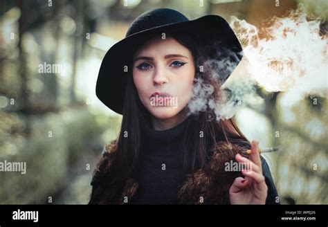 Portrait Of Beautiful Young Woman Smoking Cigarette Stock Photo Alamy