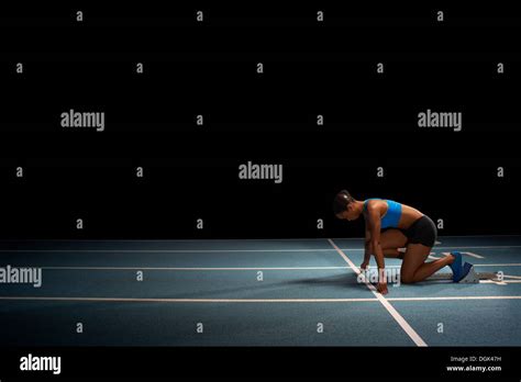 Young Female Athlete On Starting Blocks Stock Photo Alamy
