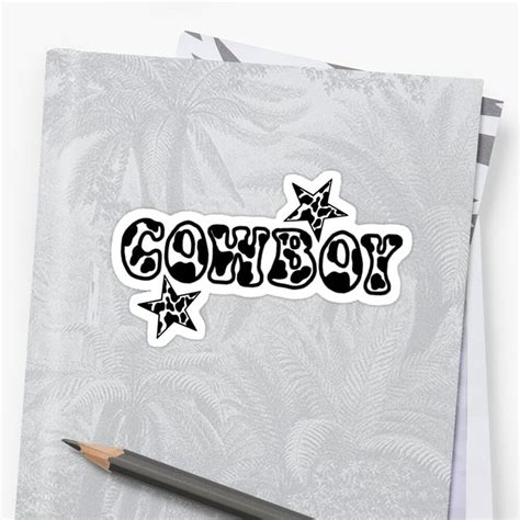 The Word Cowboy Is Written In Black And White On A Sheet Of Paper Next