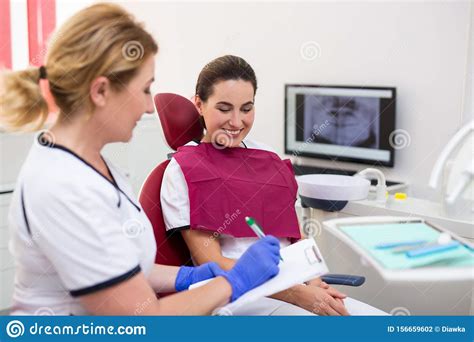 Dentist Talking With Patient Before The Treatment Stock Photo Image
