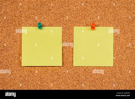 Two Empty Yellow Sticky Notes On A Cork Board With Drawing Pins Copy
