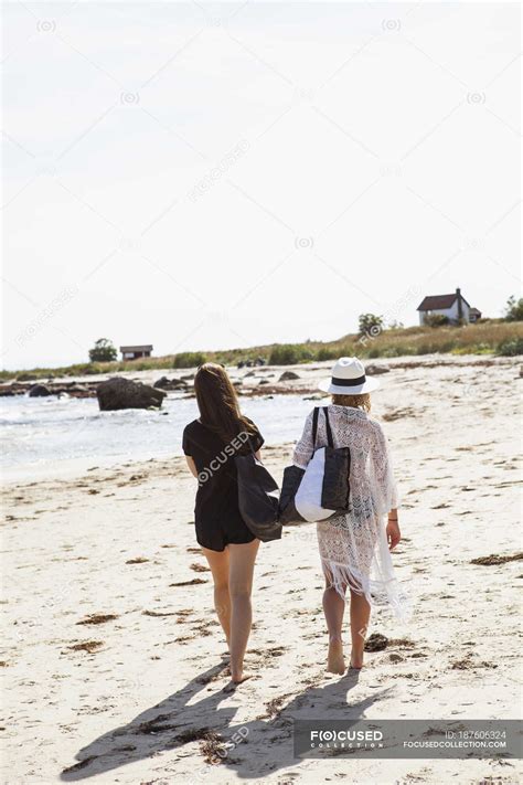 Rear View Of Teenage Girls Walking Along Beach — Teenagers Skane