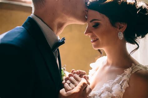 Close Up Of Groom Kissing Brides Forehead Photo Free Download