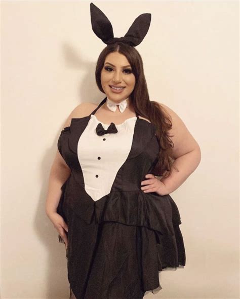 Plus Size Woman With Long Brown Hair Wearing Black Bunny Ears An A