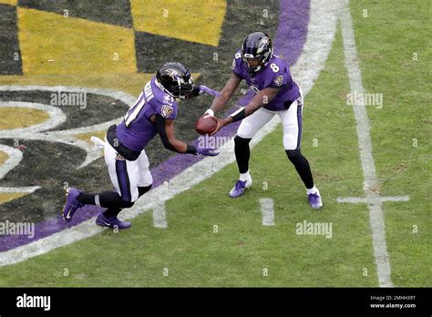 Baltimore Ravens Quarterback Lamar Jackson 8 Hands Off To Running