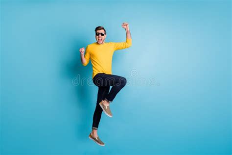 Full Size Profile Photo Of Impressed Handsome Guy Jumping Fists Up