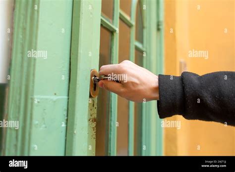 Unlocks the old green wooden entrance door Stock Photo - Alamy