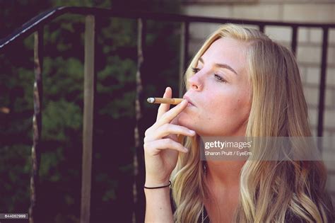 Confident Beautiful Woman Smoking Cigarette High Res Stock Photo
