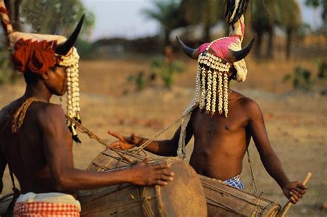 Two Young Men Of The Koya Tribe Wearing Headdresses Of Cattle Horns And Shells Play Drums