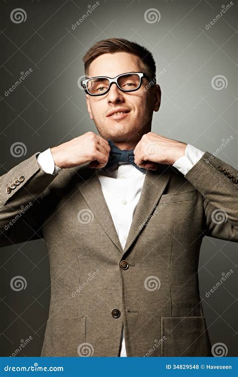 Confident Nerd In Eyeglasses Adjusting His Bow Tie Stock Photo Image
