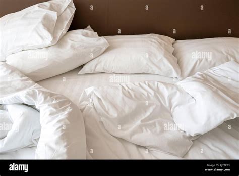 Interior Of Hotel Room In The Morning With Messy Bed Crumpled White Bed Linen Pillows And