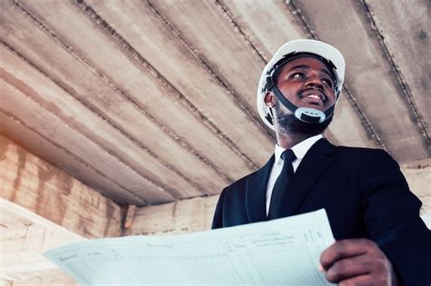 Premium Photo African Engineer Man Architect Looking At Construction