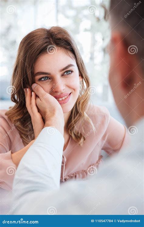 Close Up Photo Of Gentle Woman Looking On Her Man And Taking Pleasure When Holding Male Hand At