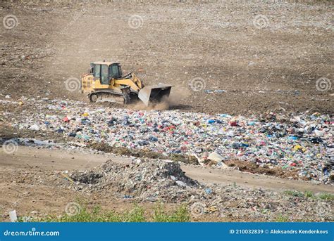 Huge Dump With Different Types Of Garbage Yellow Tractor Waste