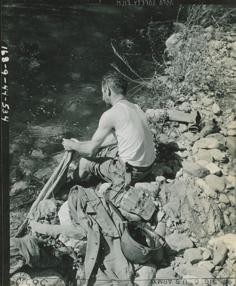 A Soldier Of The 71st Infantry Division Washing Clothes In A Cold