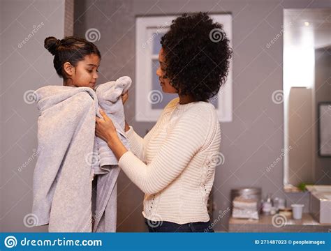 Lets Get You Dry A Mother Drying Off Her Daughter With A Towel In The
