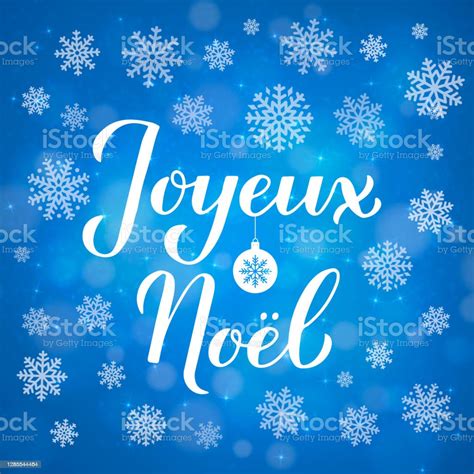 Joyeux Noel Calligraphy Hand Lettering On Blue Background With Bokeh
