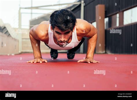 Handsome Sportsman Doing Push Ups On A Red Floor Concept Of Urban